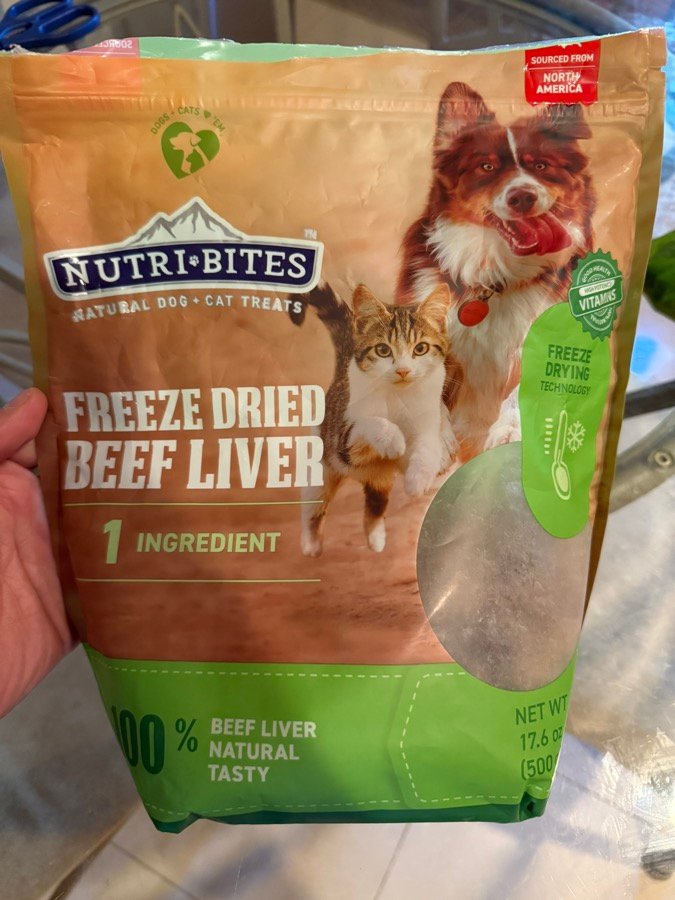 Hand holding a Nutri Bites freeze-dried beef liver bag