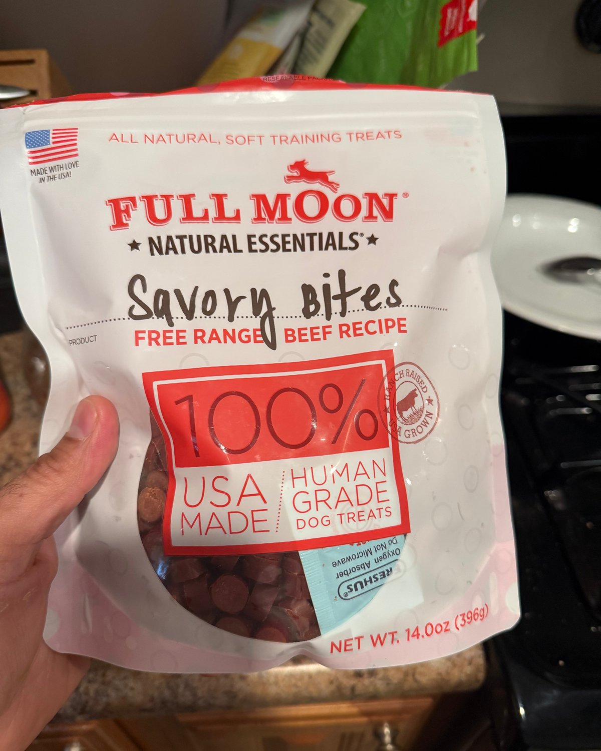 Bag of Full Moon Savory Bites beef dog treats held in hand